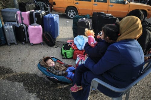 RAFAH GAZA NOVEMBER 24 Palestinians Wait With Their Luggage To