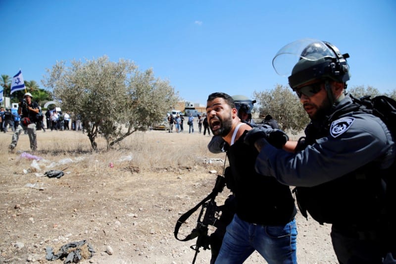 Israeli policemen detain an Arab Israeli as clashes with police erupted ...