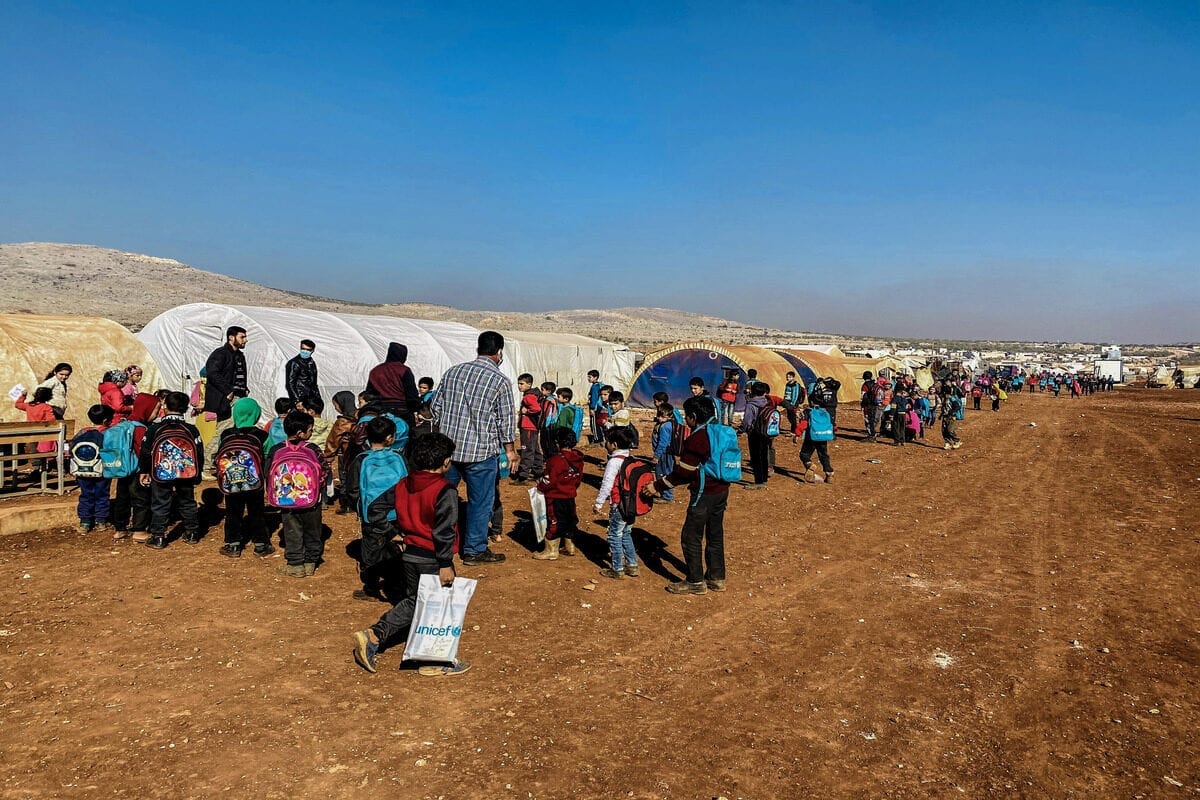 IDLIB, SYRIA - NOVEMBER 24: Children line up to take classes inside tents at Reyyan Camp in Kafr Uruq village of Idlib, Syria on November 24, 2020. Families displaced by the attacks of Assad Regime and its supporters turned tents into classrooms so the children can continue their education. Locals of Reyyan camp give lessons 4 hours a day in weekdays to the children. ( Muhammed Abdullah - Anadolu Agency )