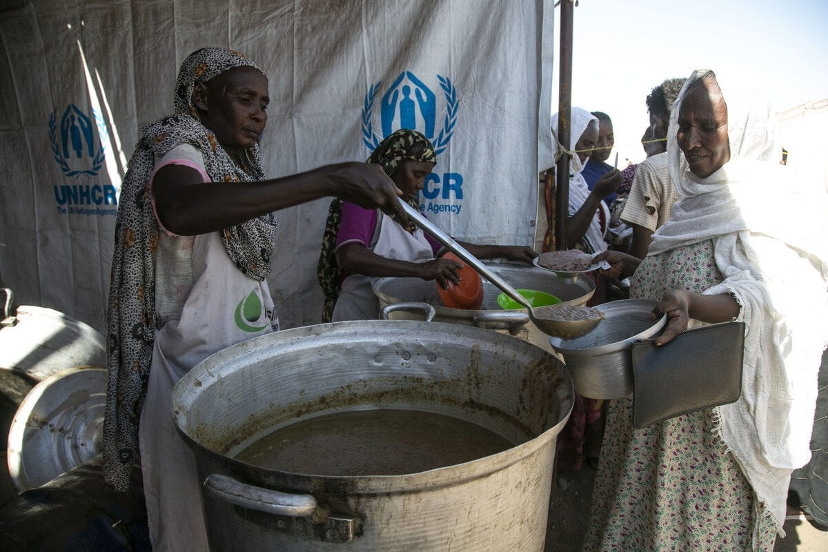 KASSALA, SUDAN - DECEMBER 14: Ethiopians, who fled the conflict in the Tigray region in northern Ethiopia due to the clashes in the operation launched by the Federal Government Forces against the Tigray People's Liberation Front (TPLF), receive food in Hamdayit camp after reaching Kassala State, Sudan on December 14, 2020. The number of refugees in neighboring Sudan has been reported to have risen to almost 50 thousand. ( Mahmoud Hjaj - Anadolu Agency )