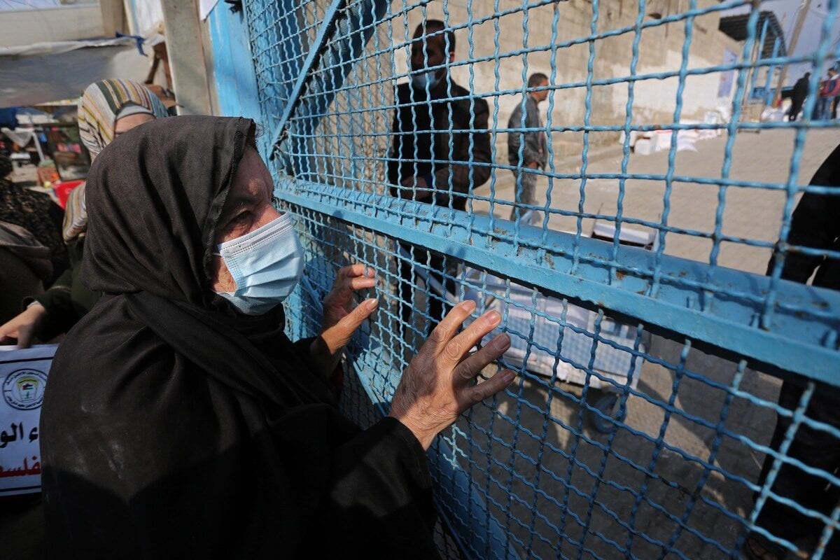 Palestinians gather in front of the United Nations Agency for Palestinian Refugees (UNRWA) in Gaza on 23 December 2020 [Ashraf Amra/Anadolu Agency]