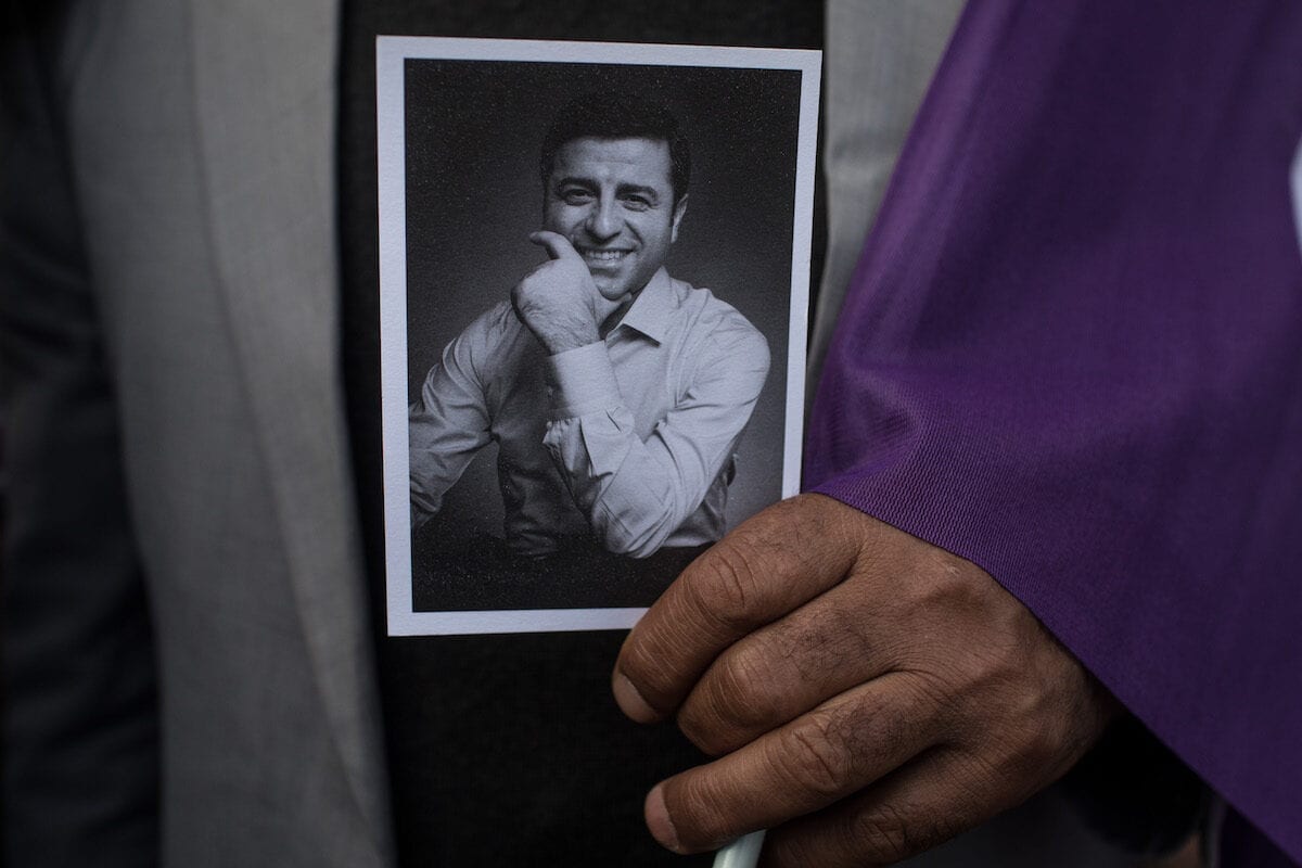 A supporter of the Pro-Kurdish Peoples' Democratic Party (HDP) holds a picture of Selahattin Demirtas on May 4, 2018 in Istanbul, Turkey [Chris McGrath/Getty Images]