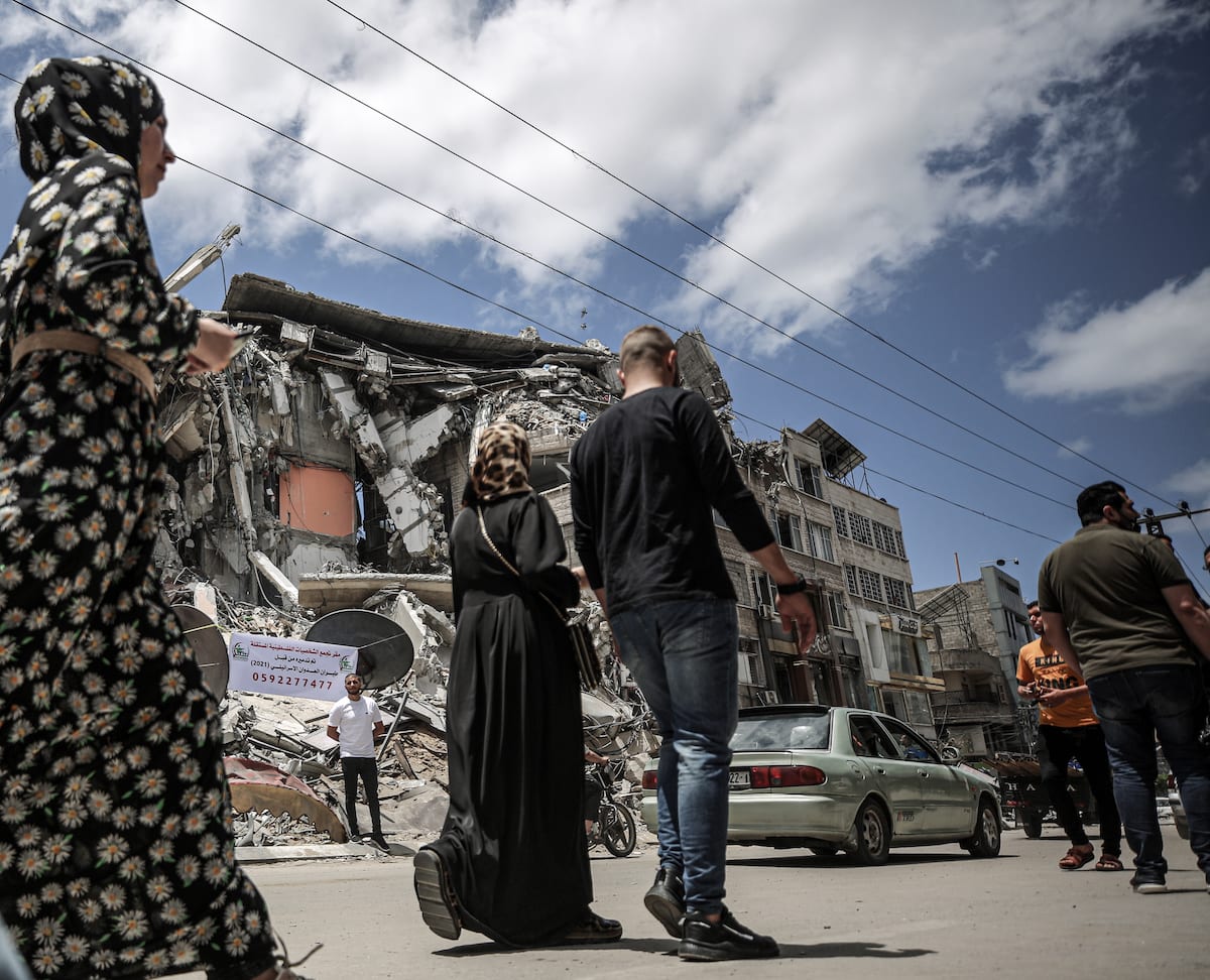 GAZA CITY, GAZA – MAY 22: Palestinians Pass By Destroyed Buildings ...