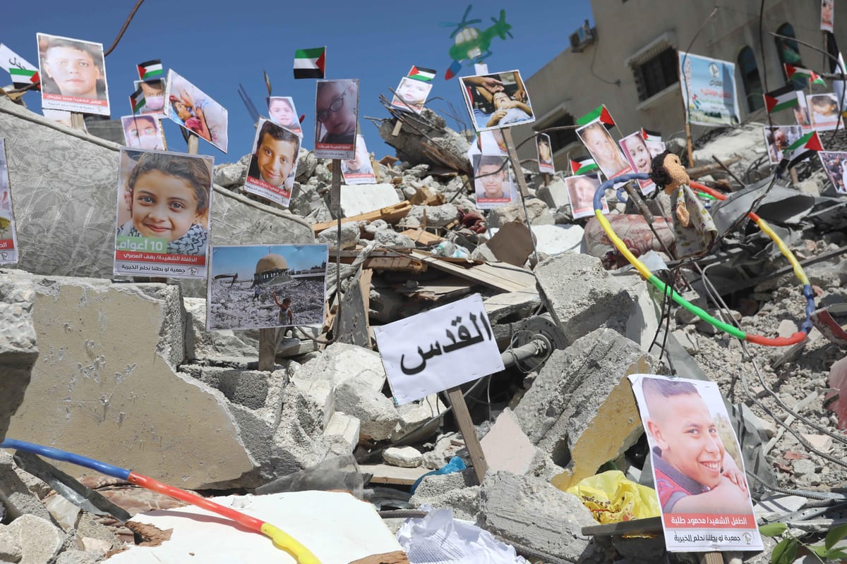 Photos Of Children Killed In Israeli Attacks Exhibited On The Rubble Of ...