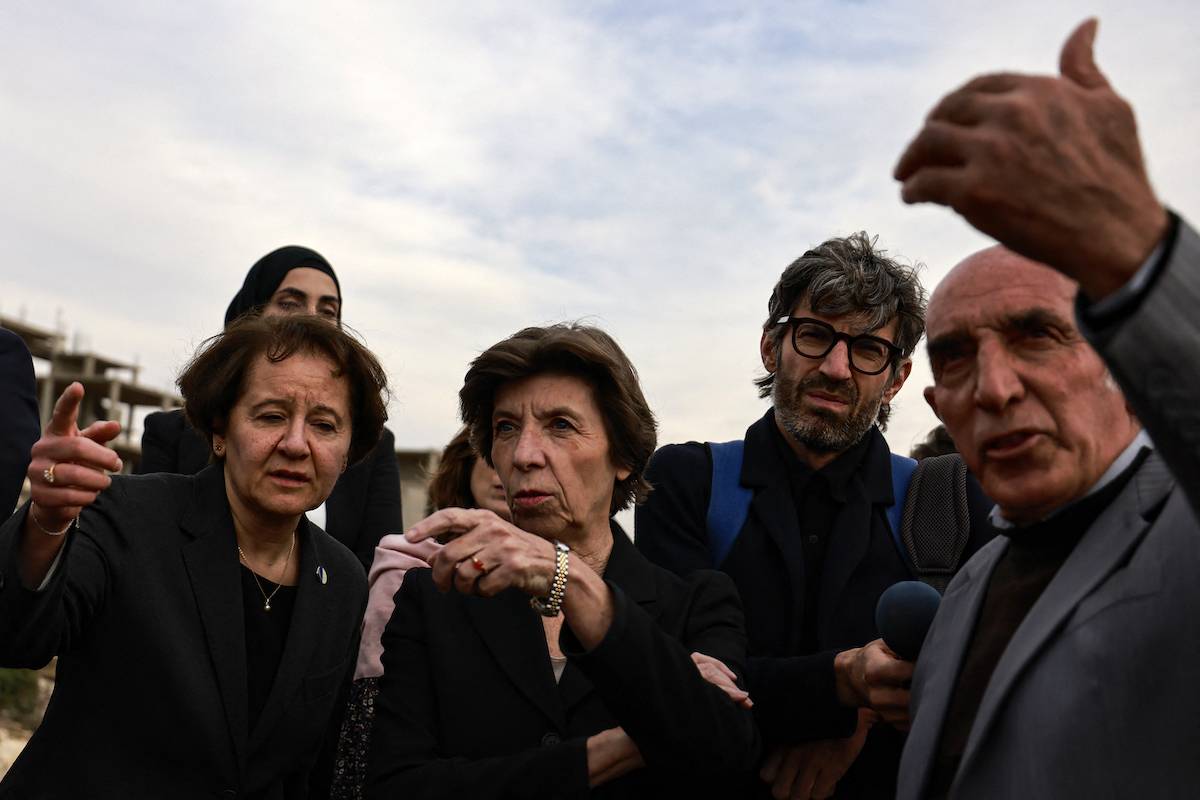 French Foreign Minister Catherine Colonna (C) meets with Palestinian olive growers in a small village near Ramallah in the occupied West Bank on December 17, 2023, amid the ongoing conflict in Gaza between Israel and the militant group Hamas. [Jaafar ASHTIYEH / AFP via Getty Images]